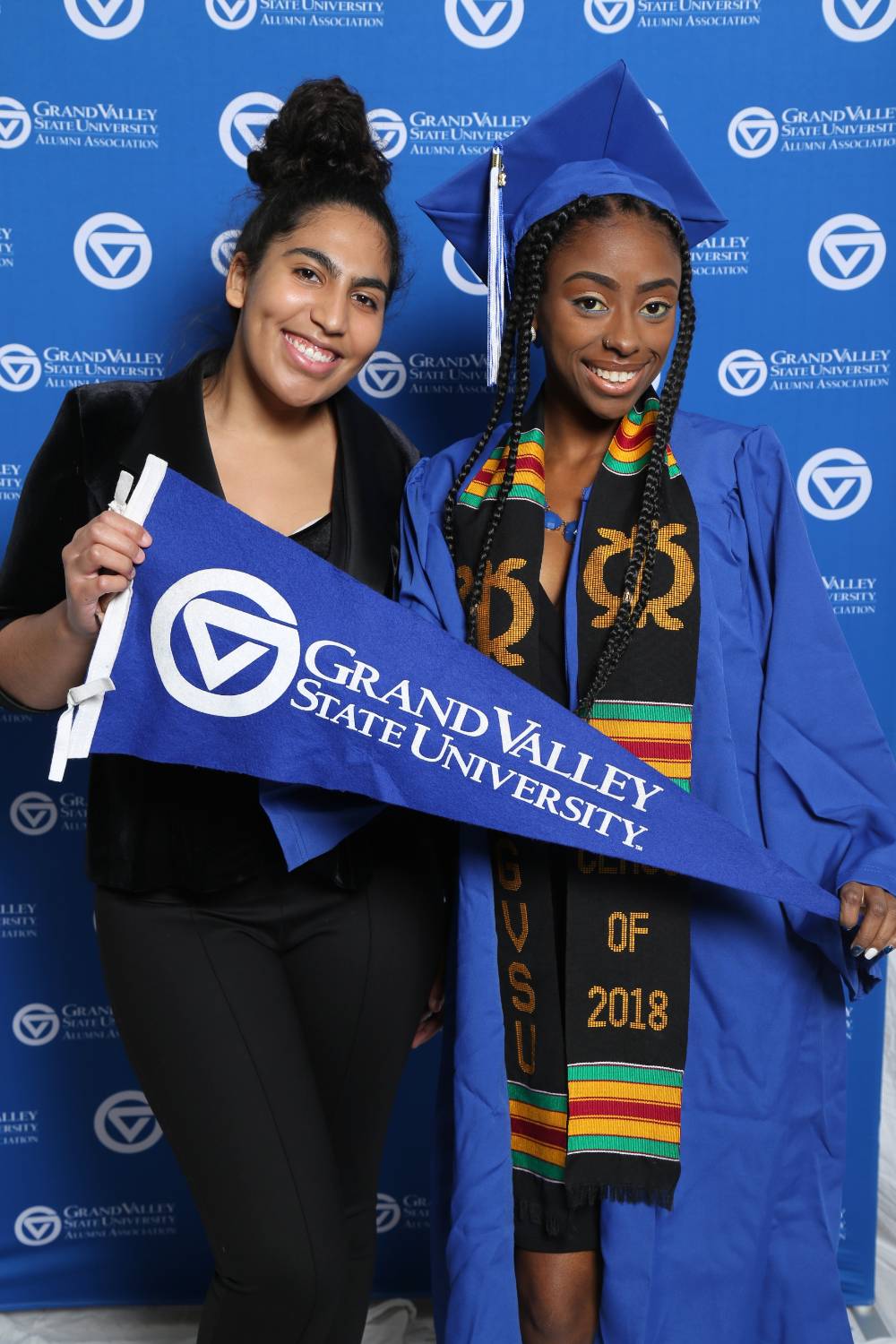Two friends pose together at Gradfest